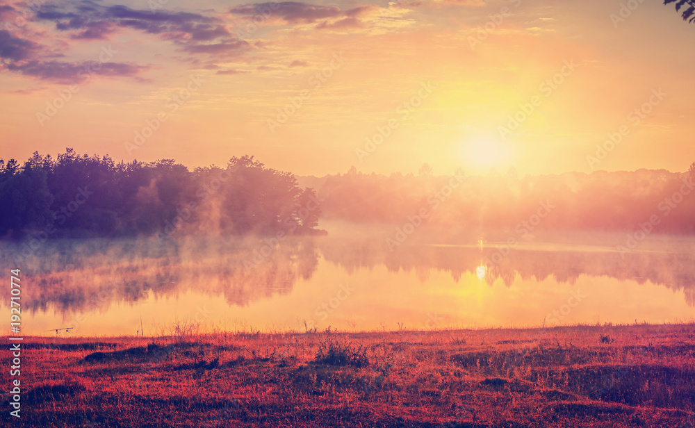 Fototapeta premium Magnificent sunny landscape. foggy lake with colorful sky, shining with sunlight. Creative image.