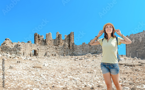 Happy woman tourist travels in famous ancient town Aspendos in Turkey, historical and archeology concept © EdNurg