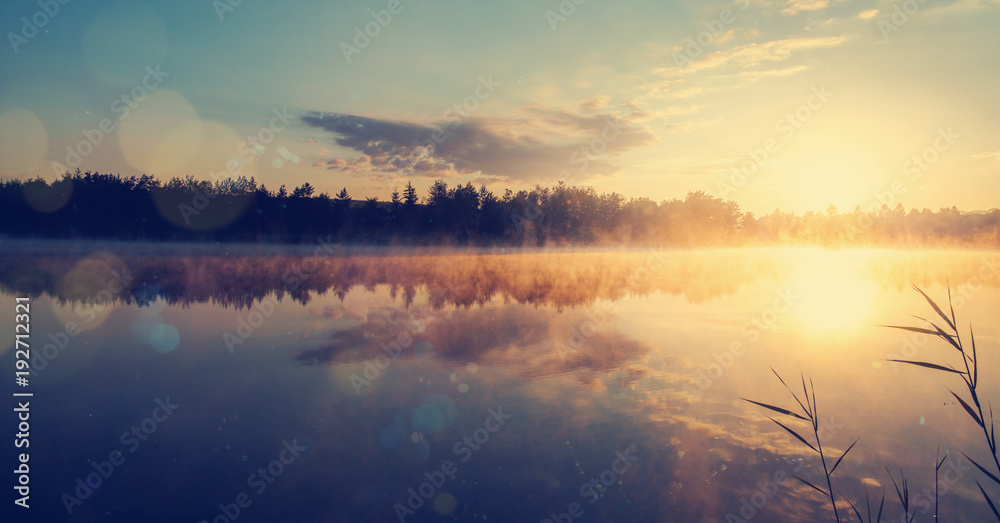 Beautiful morning landscape on a river with mist over the water.