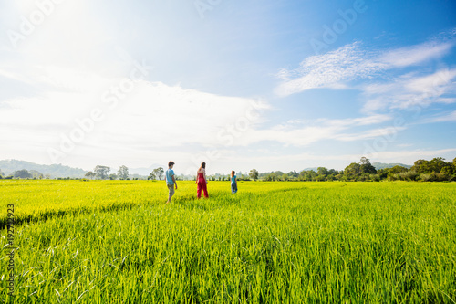 Family walking in rice field