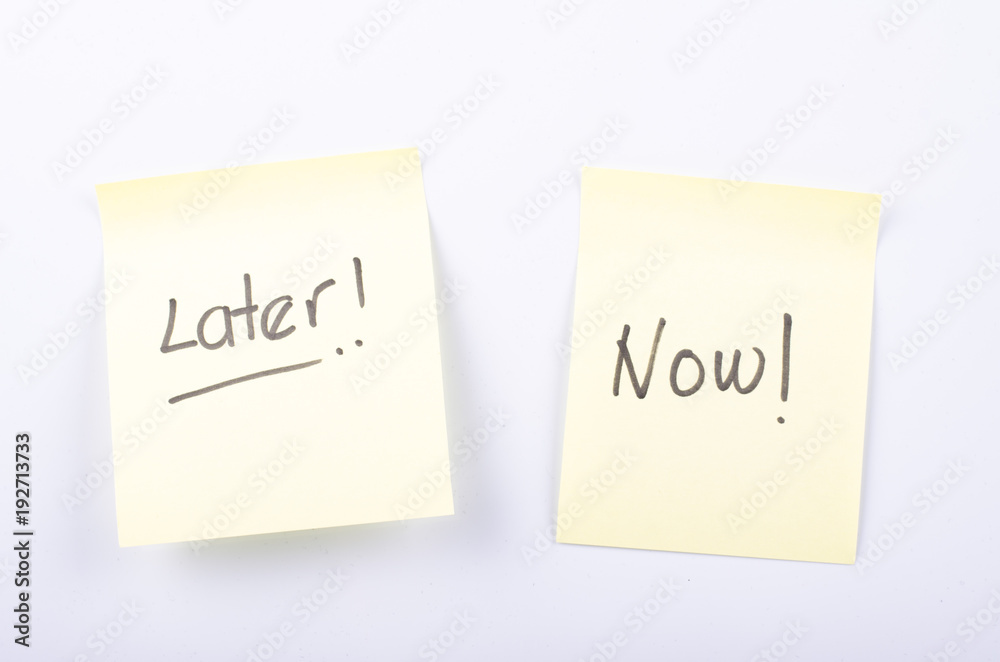 Time management and business concept, yellow sticky paper with handwriting word LATER and NOW Time management and business concept, yellow sticky paper with handwriting word LATER and NOW