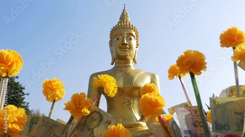 Thai Donation Money Trees in Temple of Big Golden Buddha, Pattaya. Thailand. Thai paper money on a branch of the Marigold. Wat Phra Yai Temple Or Big Buddha Statue. photo