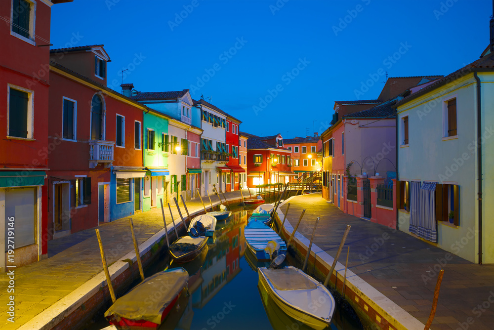 Night on the urban canal of the Burano island. Venice, Italy