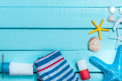 Beach Acceesories on pastel blue wooden photo