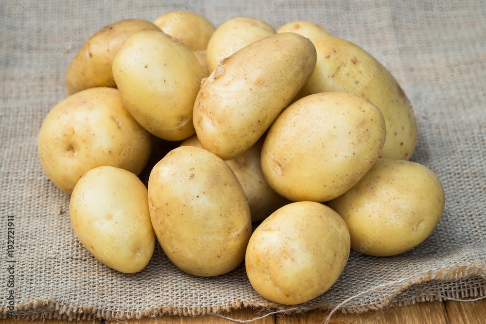 Fresh Organic Potatoes. Young Yellow Potatoes On Sackcloth With Texture Close Up. Fresh Organic Potatoes. Young Yellow Potatoes On Sackcloth With Texture Close Up.