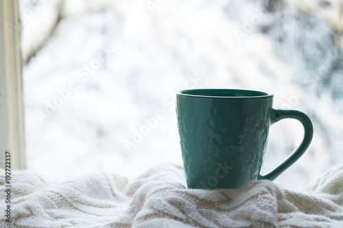 Cup Of Hot Coffee With White Warm Plaid On Windowsill Window Of House Winter.