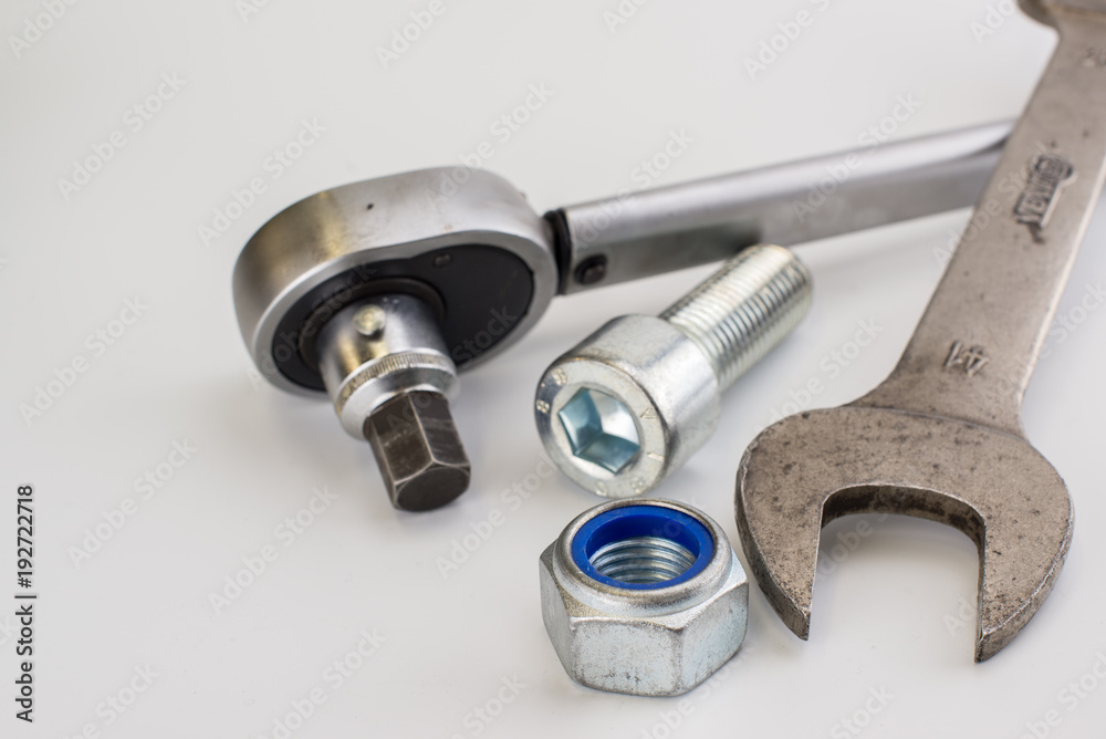 Torque wrench, spanners and nuts on white background Torque wrench, spanners and nuts on white background