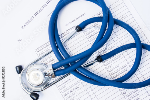 Paper form patient history and stethoscope on it. Concept of registration of patients in clinic or hospital, gathering information about disease and primary care diagnostics for preliminary diagnosis