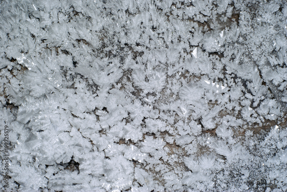 background: a section of the cave wall covered with large crystals of ice background: a section of the cave wall covered with large crystals of ice