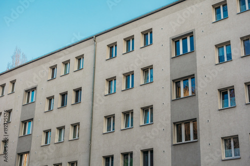 white and grey apartment building in plattenbau style