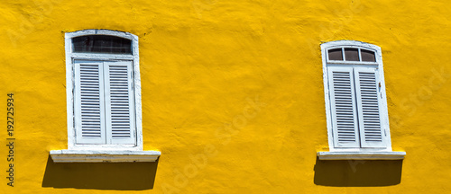 Vintage window on the yellow wall background
