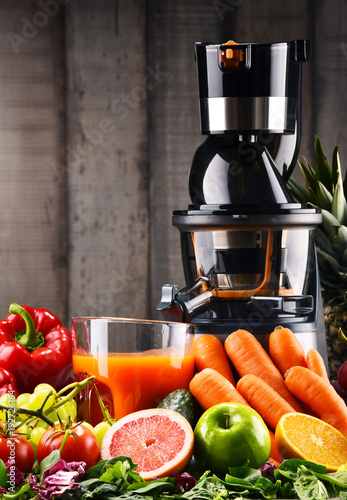 Slow juicer with organic fruits and vegetables.