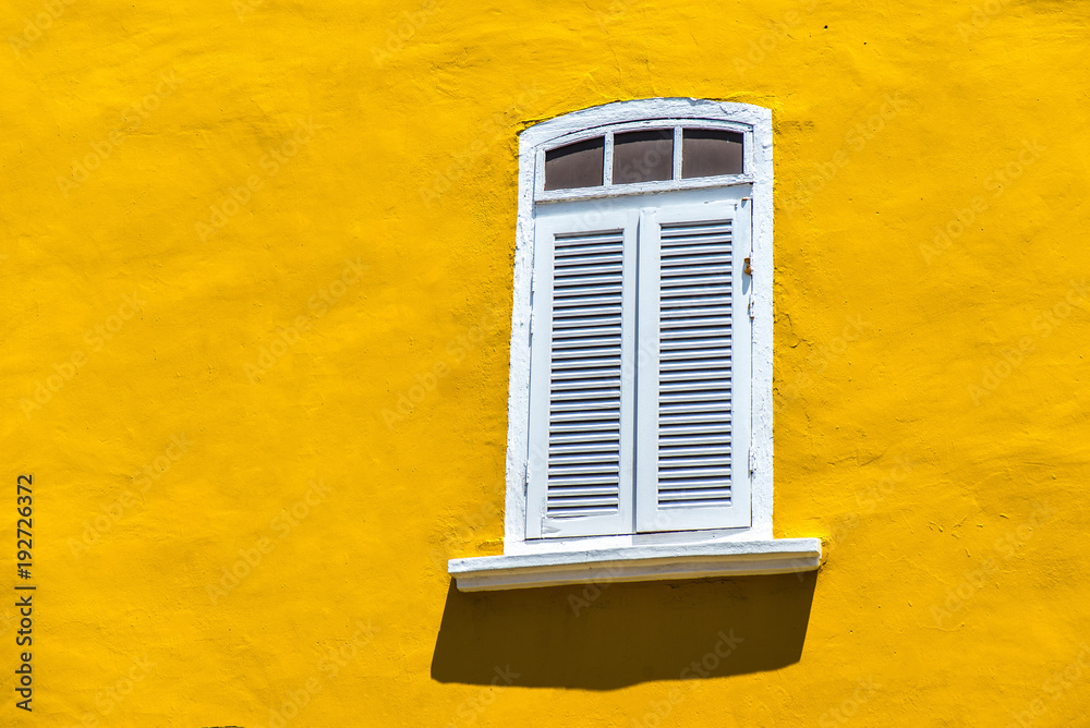 Vintage window on the yellow wall background