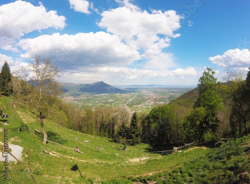 Tableau sur toile Val di Susa, beautiful view of the green valley with people standing on the gras
