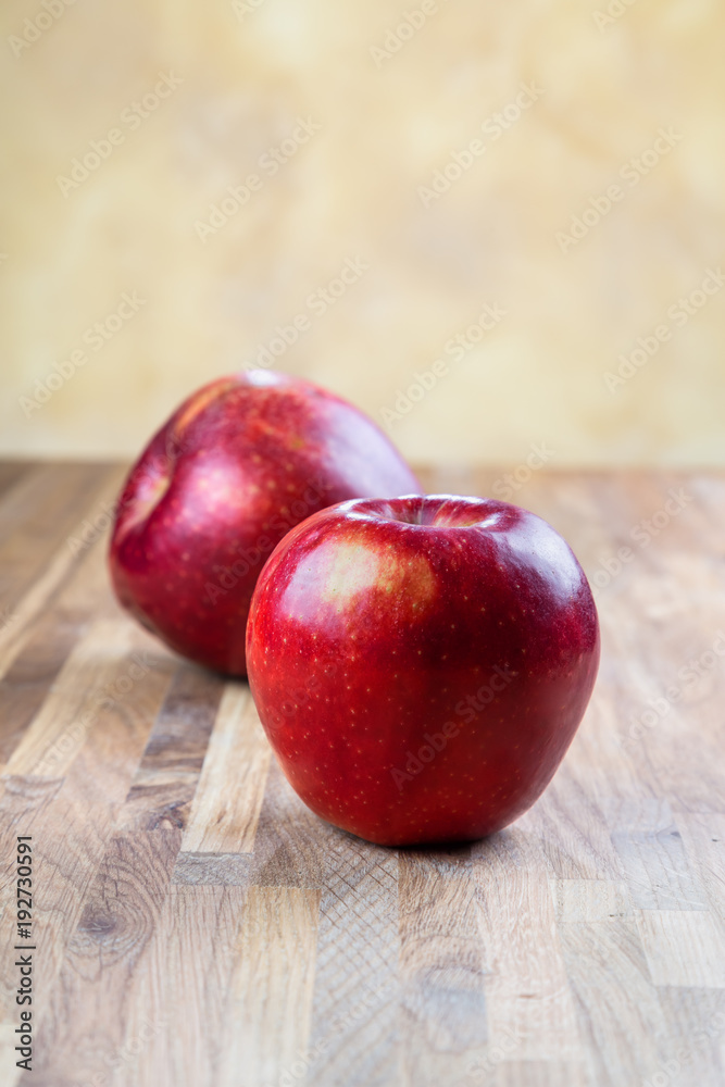 two ripe juicy apples lying on an oak table two ripe juicy apples lying on an oak table