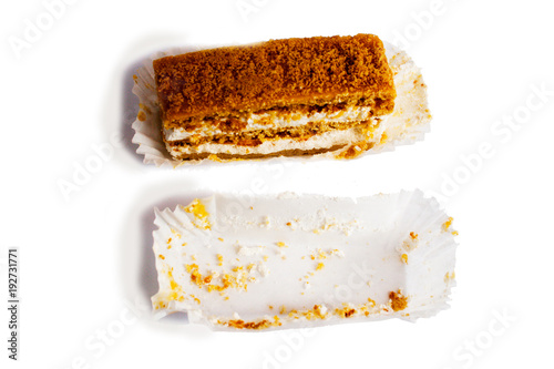 Lemon cake with cream. In a paper napkin.Isolated on a white.