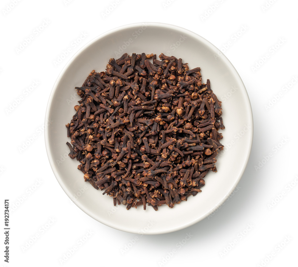 Cloves in Bowl Isolated on White Background. Top View Cloves in Bowl Isolated on White Background. Top View
