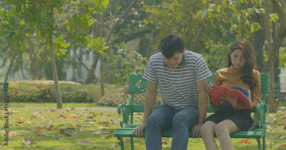 Happy young couple relaxing in the park on a bench, love concept. Happy young couple relaxing in the park on a bench, love concept.