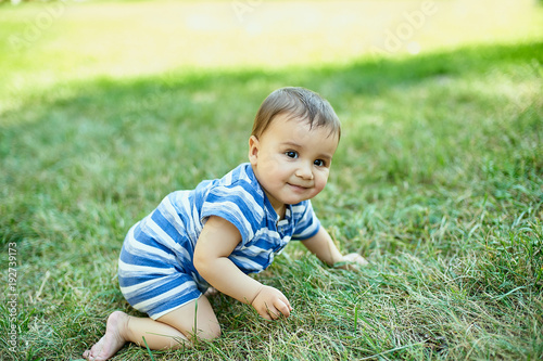 Child crawling on the grass