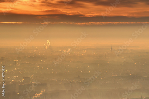 Photography Glowing winter sunrise with bright orange clouds and morning mist over houses, t