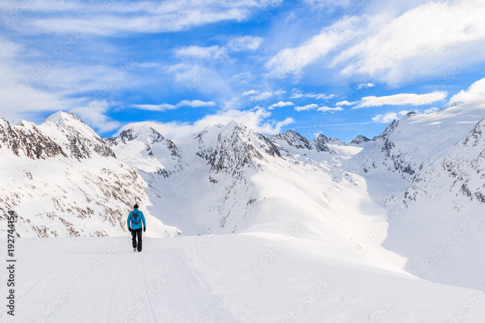 Unidentified tourist walking on snow in beautiful mountains during winter season, Obergurgl-Hochgurgl ski area, Austria