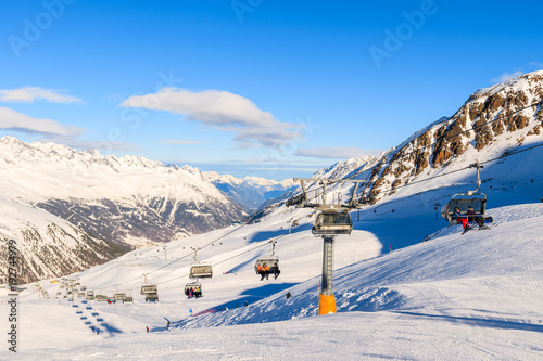 HOCHGURGL-OBERGURGL SKI RESORT, AUSTRIA - JAN 31, 2018: Skiers on chairlift in Hochgurgl-Obergurgl ski area on sunny winter day, Tirol, Austria.