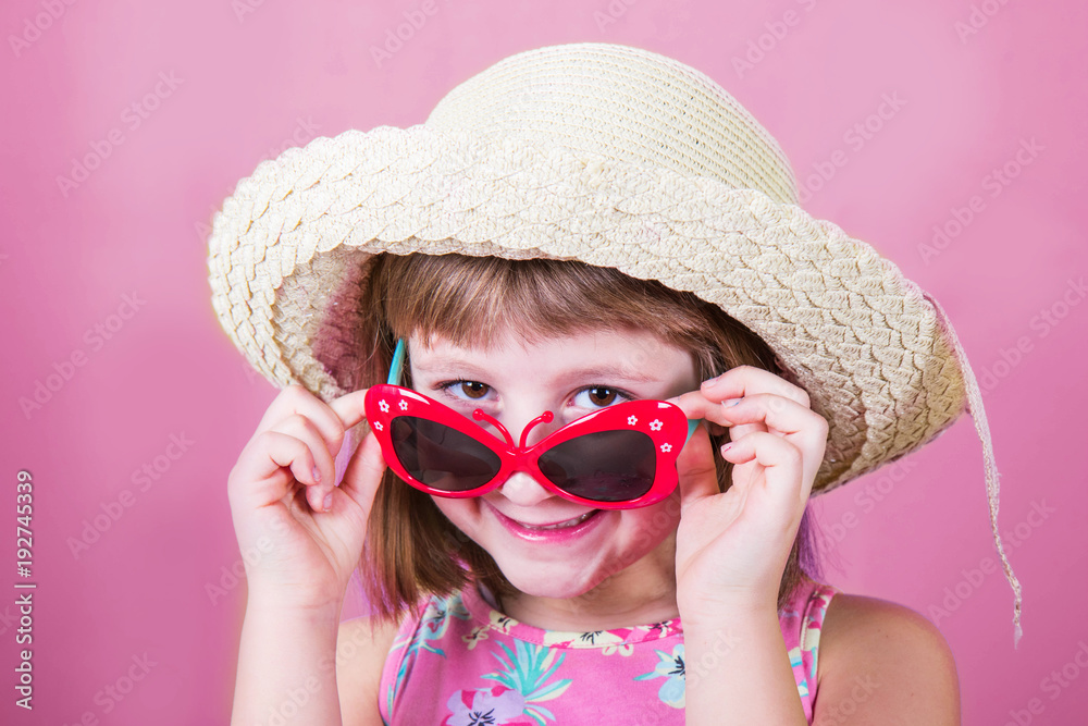 smiling little girl in straw hat and sunglasses smiling little girl in straw hat and sunglasses