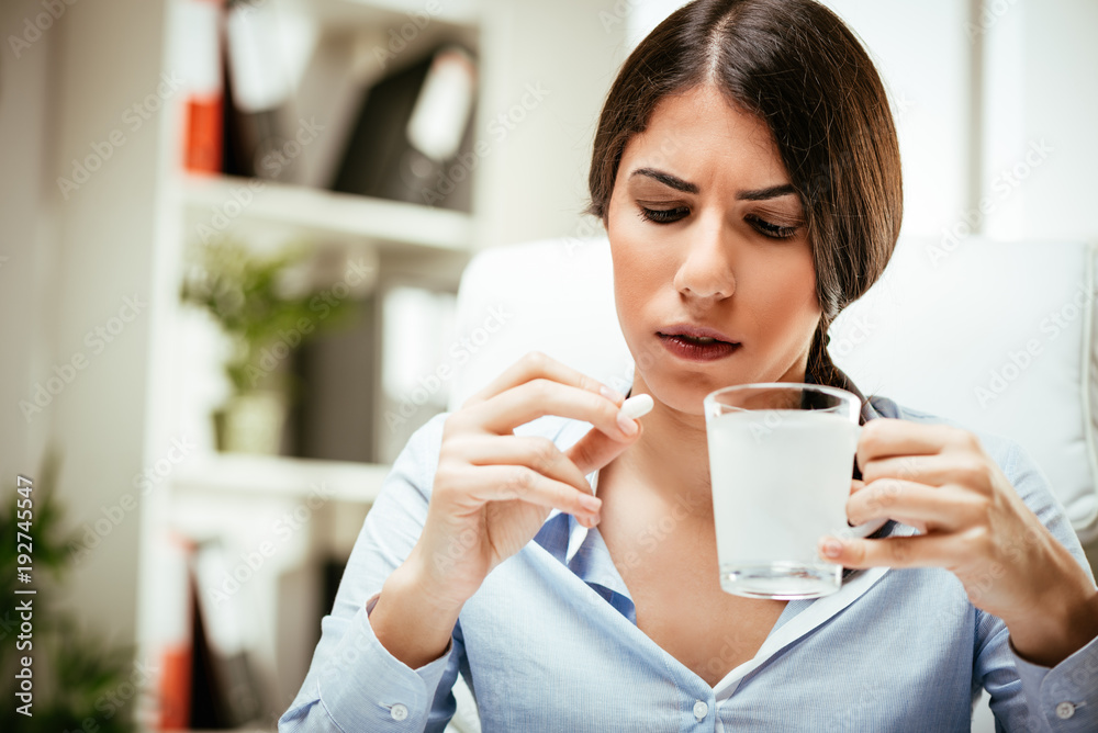 Young Woman Takes A Pill At Work Young Woman Takes A Pill At Work