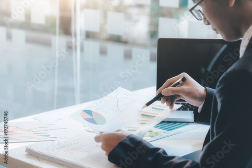 Businessman using computer to analyse the investment. photo