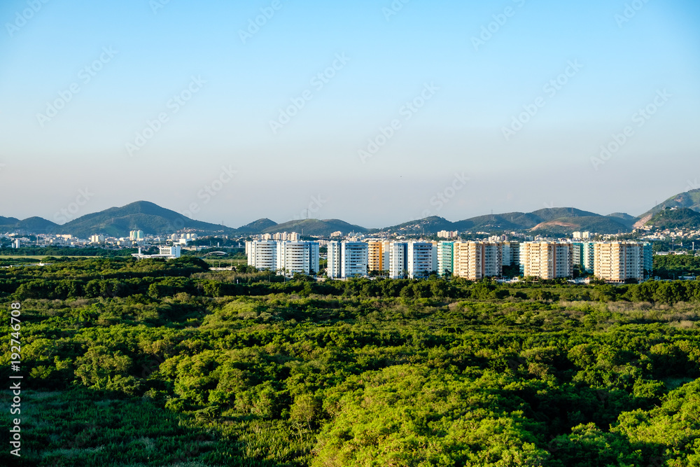 Fototapeta premium Forest landscape with condos in the background, near Vila Panamericana, Barra da Tijuca, Rio de Janeiro
