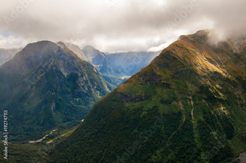 High mountains in dramatic weather scenic view, Mackinnon Pass, Fiordland National Park, New Zealand photo