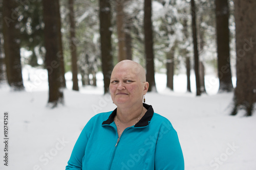 Cancer patient with bald head in woods