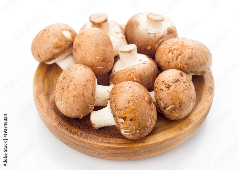 group of whole mushrooms on wooden tray, isolated on white background group of whole mushrooms on wooden tray, isolated on white background