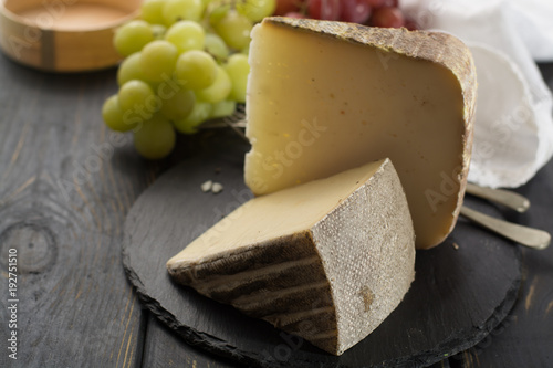 Tasting of ancient french demi soft cheese Tomme from French Alps, made from cow, goat or sheep skim milk, low fat french cheese photo