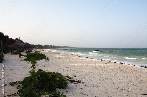 White sand beach in Zanzibar, Tanzania (Africa) during the evening photo