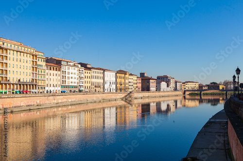 Arno river embankment with colorful old houses in Pisa. Picturesque medieval town of Pisa from bridge Ponte di Mezzo, Pisa, Tuscany, Italy. © umike_foto