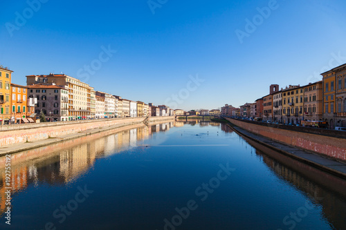 Arno river embankment with colorful old houses in Pisa. Picturesque medieval town of Pisa from bridge Ponte di Mezzo, Pisa, Tuscany, Italy.
