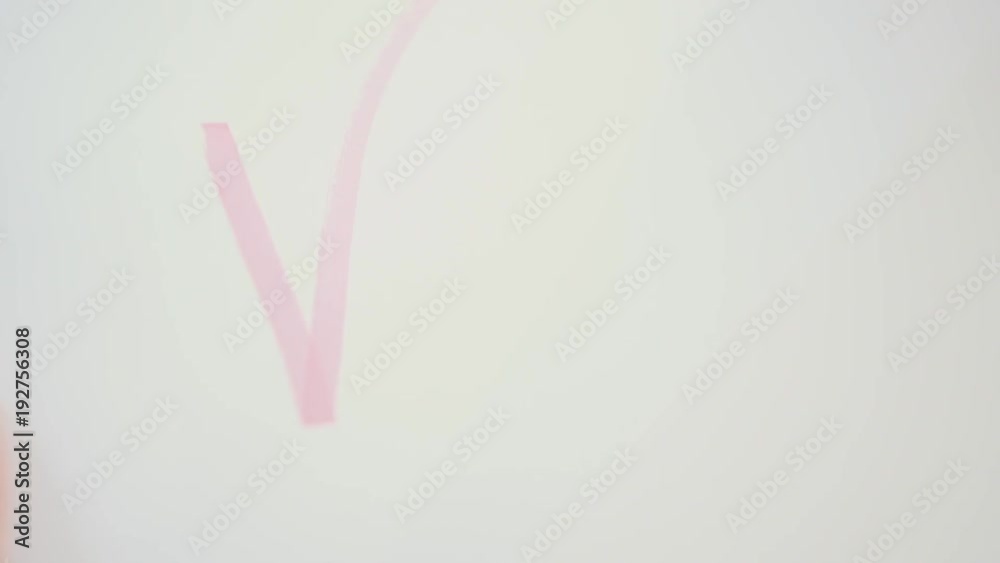 Female draws pink check mark on paper Female draws pink check mark on paper