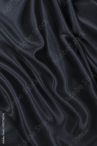Smooth elegant dark grey silk or satin texture as abstract background. Luxurious background design