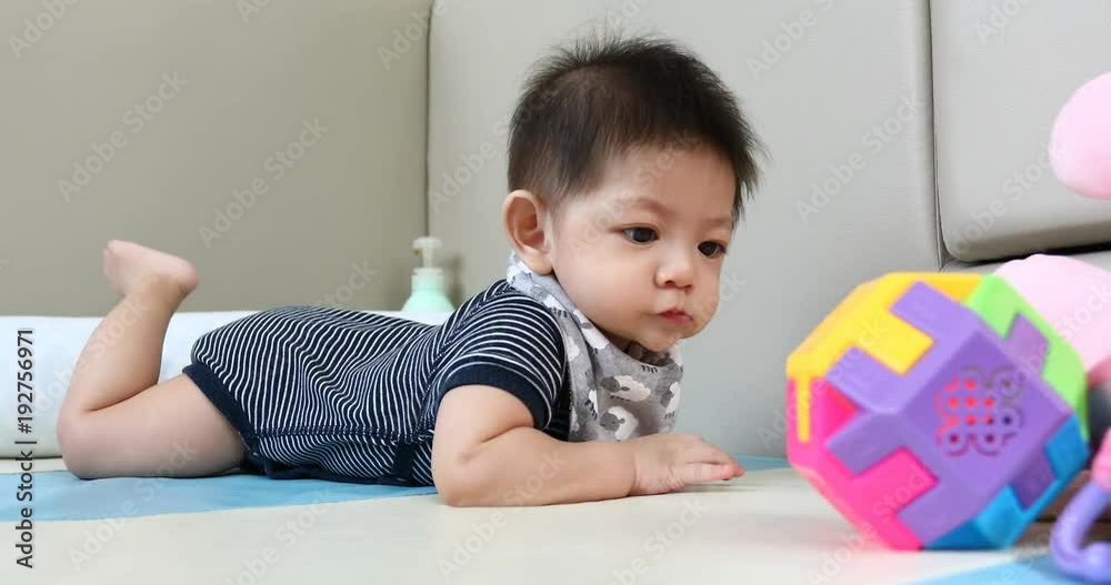 cute asian baby boy playing ball toy on soft mattress floor in nursery room cute asian baby boy playing ball toy on soft mattress floor in nursery room
