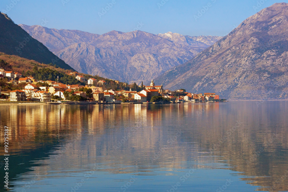 Mediterranean landscape with reflection in water. View of Bay of Kotor  ( Adriatic Sea ) and Prcanj town, Montenegro, winter
