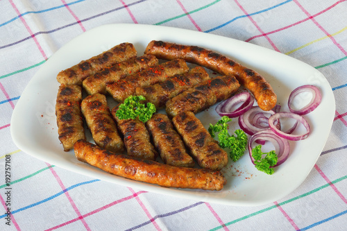 Balkan cuisine. Cevapi and kobasica  - grilled dish of minced meat photo