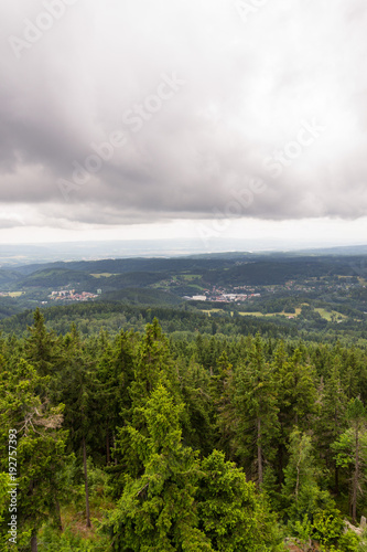 Beautiful summer forest view from Pajndl lookout tower cloudy sky copy space, Tisovsky Mount in Krusne Hory, Bohemia, Czech Republic