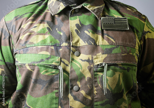 Closeup photo of a male chest standing in military jacket.