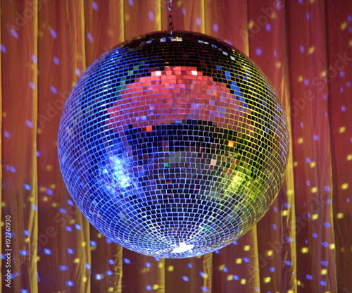 night club lighting red-blue mirror-ball over curtains