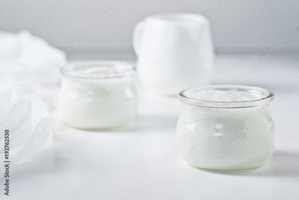 Yogurt in two jars with milk jug Yogurt in two jars with milk jug