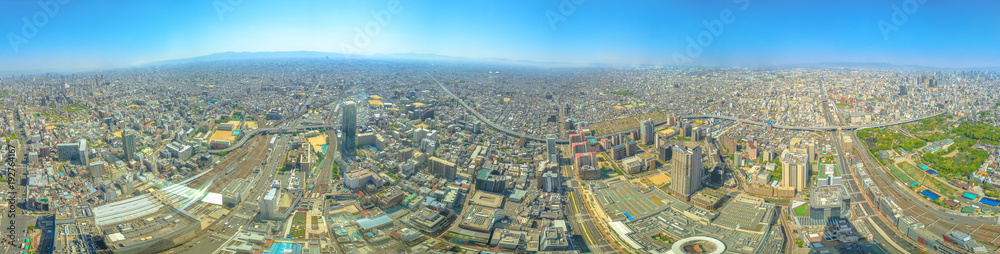 Panorama background of Osaka skyline from observation deck of Osaka's Abeno Harukas, the tallest skyscraper in Japan. Aerial view of Kintetsu Osaka Abenobashi Station and JR Tennoji Station.Copy space