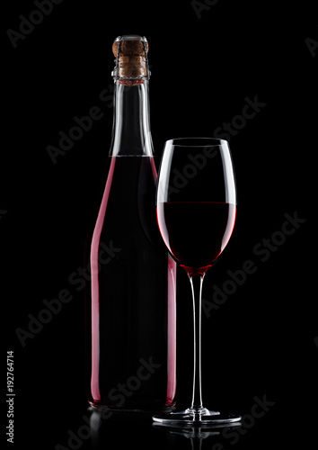 Bottle of homemade red wine and glass with cork