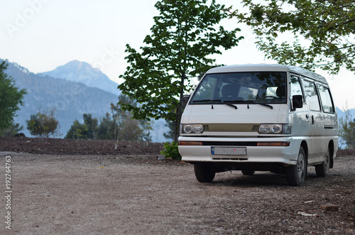 van is parked on background mountains