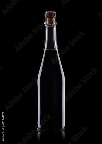 Homemade bottle of red wine with cork on black